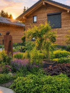 a garden of flowers in front of a building at Allgäuer Bergwald Chalets in Oberstaufen