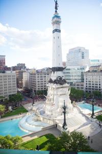 a large white tower in a city with a fountain at Columbia Club in Indianapolis