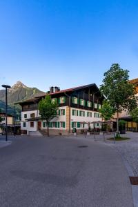 a large white building with trees in front of it at Münsterhus Josefs Alpine Lodge in Schruns