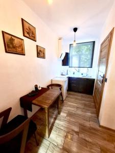 a small room with a table and a sink at Oāze Aucē in Auce