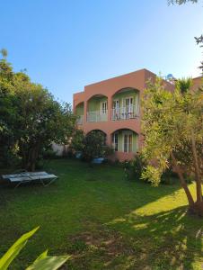 a large building with a yard in front of it at Livadi Apartments in Plakias