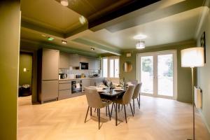 a kitchen and dining room with a table and chairs at The Whitehouse - Flat B in Carbis Bay
