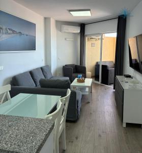 a living room with a couch and a table at ESTUDIOS CHINASOL - Bernardo Cózar in Almuñécar