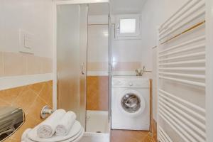 a bathroom with a washing machine and a washer at Villa Aurora with Sea View in Seravezza +72 photos