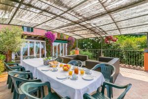 a table and chairs under a pergola on a patio at Villa Aurora with Sea View in Seravezza