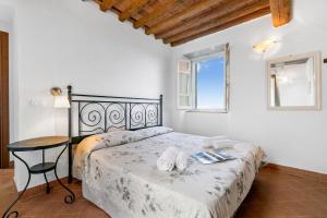 a bedroom with a bed with two towels on it at Villa Aurora with Sea View in Seravezza