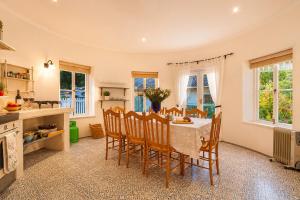 a kitchen and dining room with a table and chairs at Constantia The Silos in Sweet Valley +26 photos