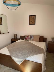 a bedroom with a bed and a mirror at Casa Sandrina in Caprino Veronese