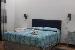 a bedroom with a bed with towels on it at Casa Mille Lire in Ciampino