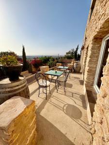 a patio with a table and chairs on a building at Chez les copains in Sidi Kaouki