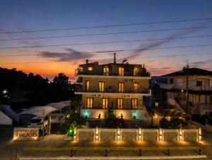 a building with lights in front of it at night at THEASIS 5 luxury studio with sea view in Neos Marmaras +12 photos
