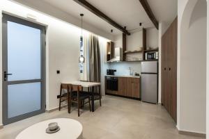 a kitchen and dining room with a table and a window at ARCH Luxury Suites in Archangelos +13 photos