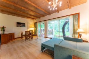 a living room with a couch and a table at Club Mahindra Golden Landmark, Mysuru in Mysore