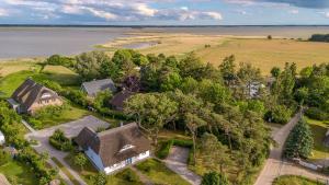 an aerial view of a house on the shore of a lake at Haus Tadder in Born
