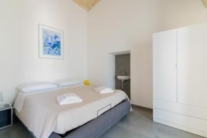 a white bedroom with a bed and a cabinet at Villa Queen by Perle di Puglia in Lecce +38 photos