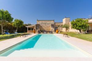 a swimming pool in the backyard of a house at Villa Queen by Perle di Puglia in Lecce