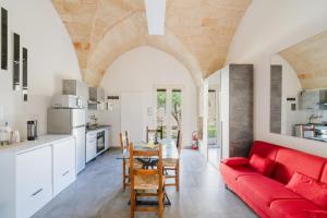a living room with a red couch and a table at Villa Queen by Perle di Puglia in Lecce