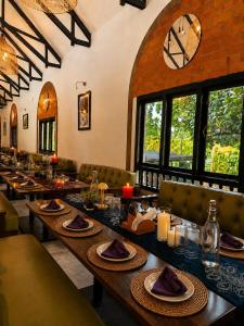 a dining room with a long table with plates of food at DZION Resort Coorg in Gonikoppal