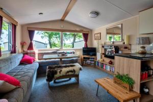 a living room with a couch and a table at Finest Retreats - Seascape in Porchfield