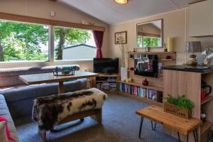 a living room with a couch and a table at Finest Retreats - Seascape in Porchfield