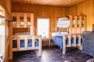 a bedroom with two bunk beds in a cabin at Tall Tine Lodge in La Prairie