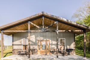 a barn house with a metal roof at Tall Tine Lodge in La Prairie