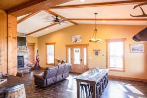 a living room with a couch and a table at Tall Tine Lodge in La Prairie