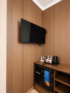 a room with a flat screen tv on a wall at Гостиница Балхаш in Balqash