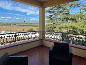 a balcony with chairs and a view of a field at Villa Bice in Pulsano