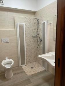 a bathroom with a shower and a toilet and a sink at Villa Bice in Pulsano +27 photos