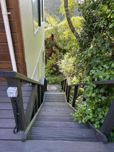 a wooden walkway leading up to a house at Spacious peaceful apartment in Wellington +15 photos