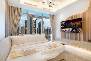 a bedroom with a large bed with a large window at Downtown Dubai's Highest Infinity Pool, Paramount Hotel Midtown in Dubai
