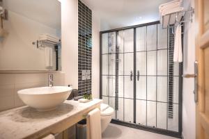a bathroom with a sink and a toilet at Villa Lukka in Cıralı +107 photos