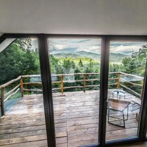 a view of a deck from a room with sliding glass doors at Chata na samote in Revúca