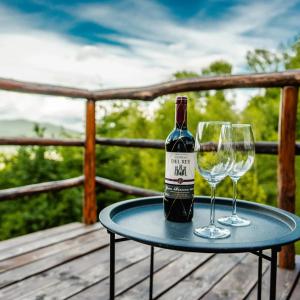 a bottle of wine and a glass on a table at Chata na samote in Revúca