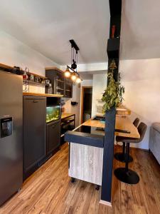 a kitchen with a island in the middle of a room at Villa GoldenPearl in Povile +9 photos