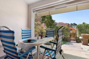 a table and chairs on a patio with a view at Bilo Lu Impostu in Nuragheddu