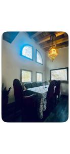a dining room with a table and chairs and a chandelier at Chalet Havana in Namur