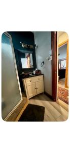 a bathroom with a mirror and a dresser with a sink at Chalet Havana in Namur +4 photos