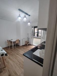 a kitchen and dining room with a table and lights at Affittacamere Torresi in Ancona