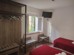 a bedroom with a red bed and a window at Affittacamere Torresi in Ancona