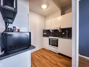 a small kitchen with a tv on a counter at Nässjö Vandrarhem in Nässjö +35 photos