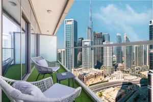 a balcony with chairs and a view of the city at Downtown Dubai's Highest Infinity Pool, Paramount Hotel Midtown in Dubai