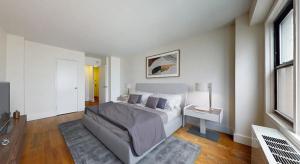 a white bedroom with a bed and a table at rock sidecoast in Quismondo
