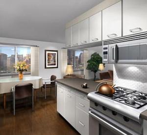 a kitchen with a stove and a dining room with a table at rock sidecoast in Quismondo