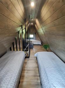 a room with two beds in a room with at Chata Bosorečka in Smižany