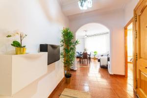 a living room with white walls and a tile floor at Casa Maruchi Apartamento 2 in Almería