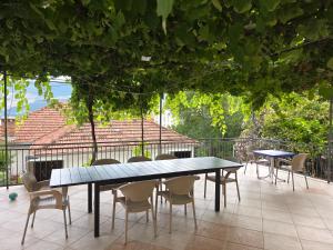 a table and chairs sitting on a patio at Garden Terrace Apartment in Igalo