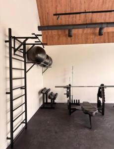 a gym with two treadmills and a weights at Domek Reset Kaszuby - Basen, Jacuzzi, Sauna, Siłownia in Łączyno +32 photos