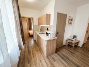 a small kitchen with a microwave on a counter at Hilson Jasna - Garden resort in Liptovský Mikuláš +81 photos